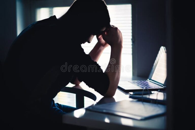 silhouette stressee au bureau ambiance sombre